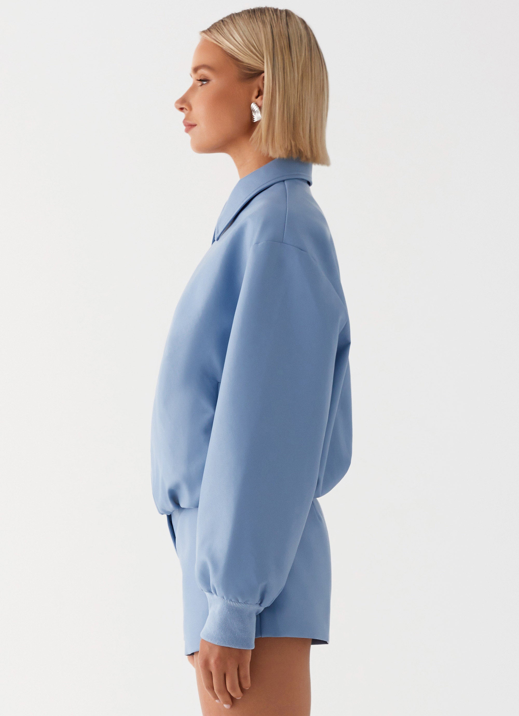Womens Aspen Oversized Bomber Jacket in the colour Blue in front of a light grey background