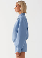 Womens Aspen Oversized Bomber Jacket in the colour Blue in front of a light grey background