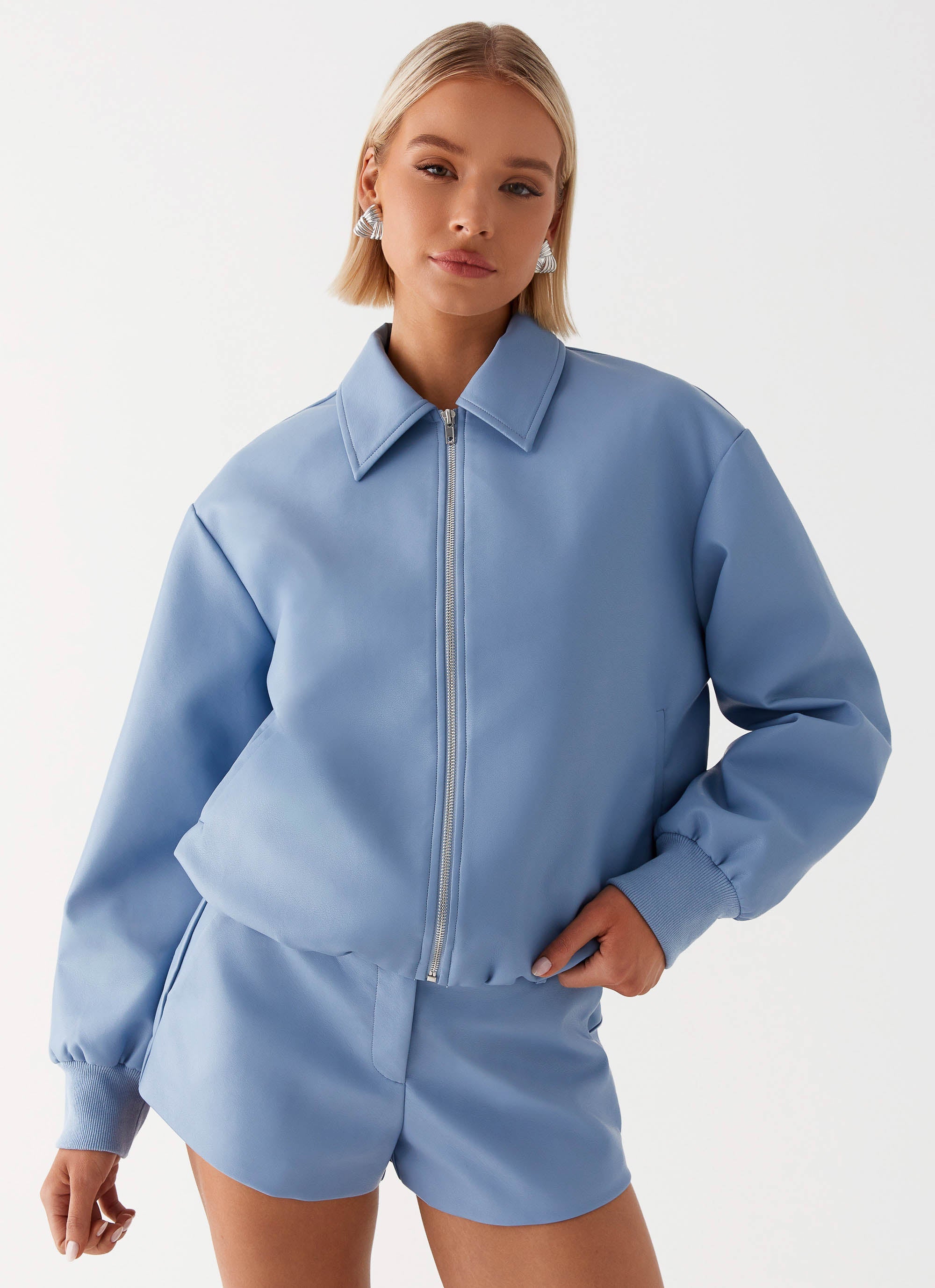 Womens Aspen Oversized Bomber Jacket in the colour Blue in front of a light grey background