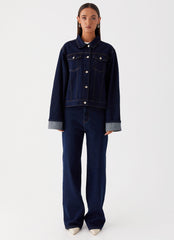 Womens Back Again Oversized Denim Jacket in the colour Blue in front of a light grey background