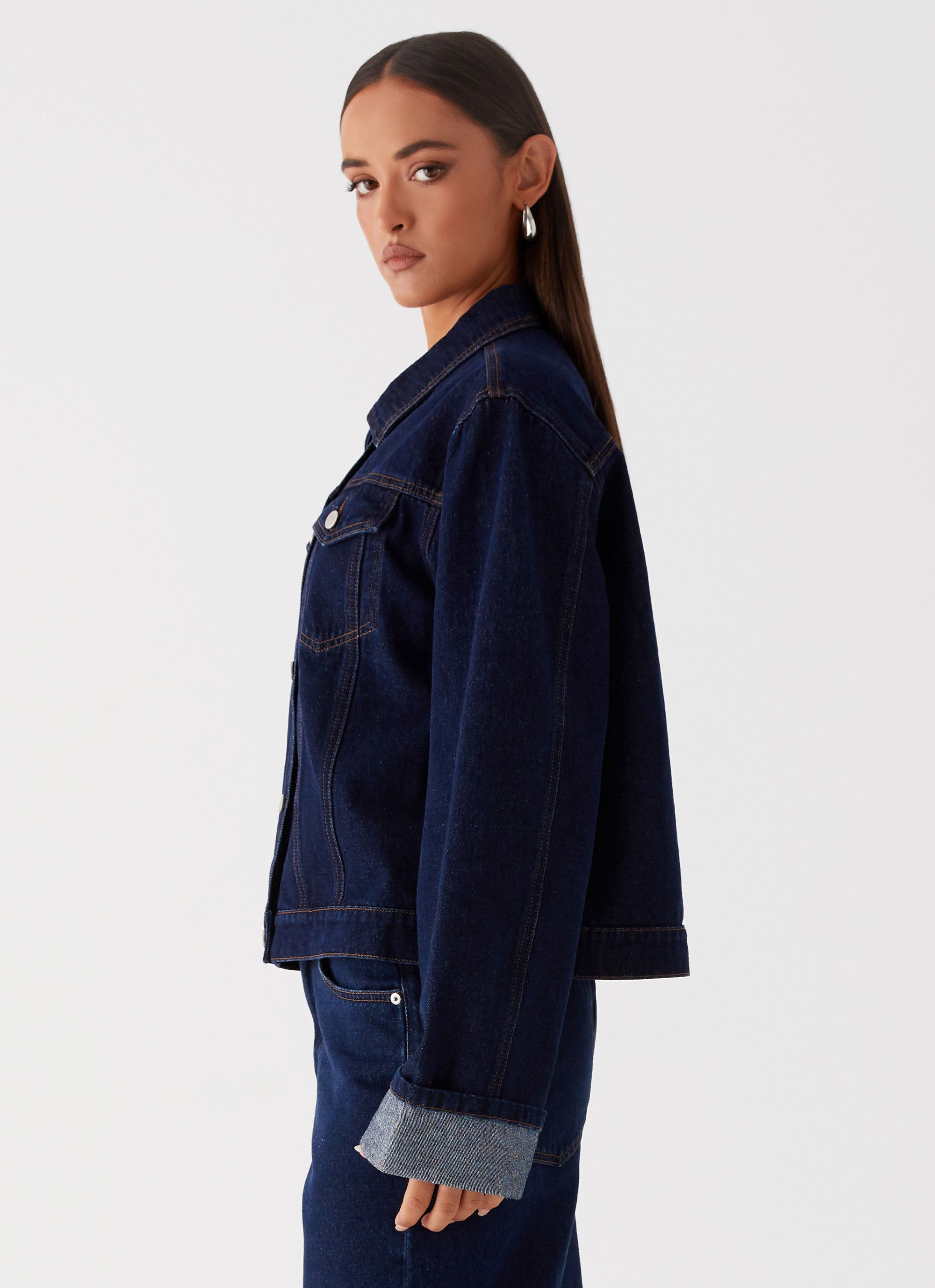 Womens Back Again Oversized Denim Jacket in the colour Blue in front of a light grey background