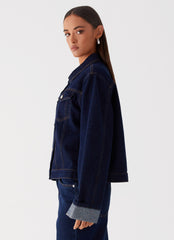 Womens Back Again Oversized Denim Jacket in the colour Blue in front of a light grey background