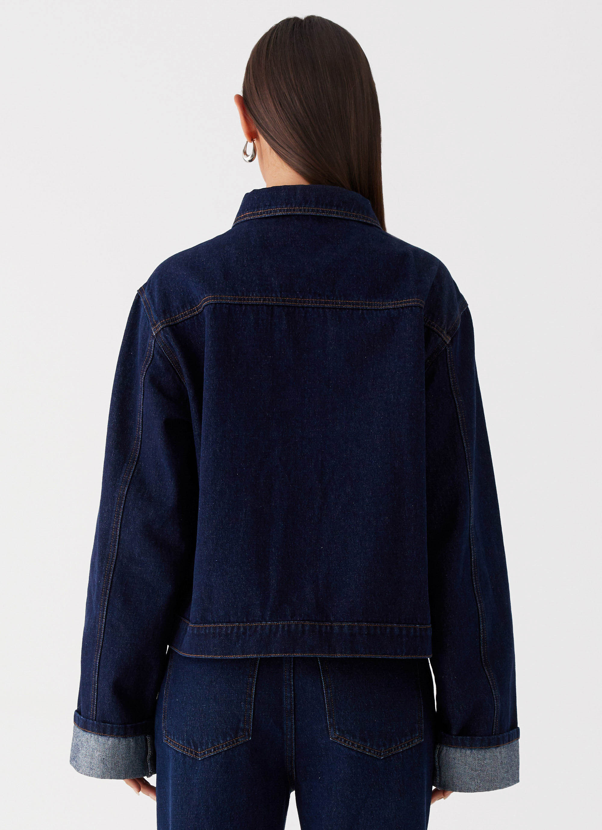 Womens Back Again Oversized Denim Jacket in the colour Blue in front of a light grey background