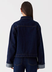 Womens Back Again Oversized Denim Jacket in the colour Blue in front of a light grey background
