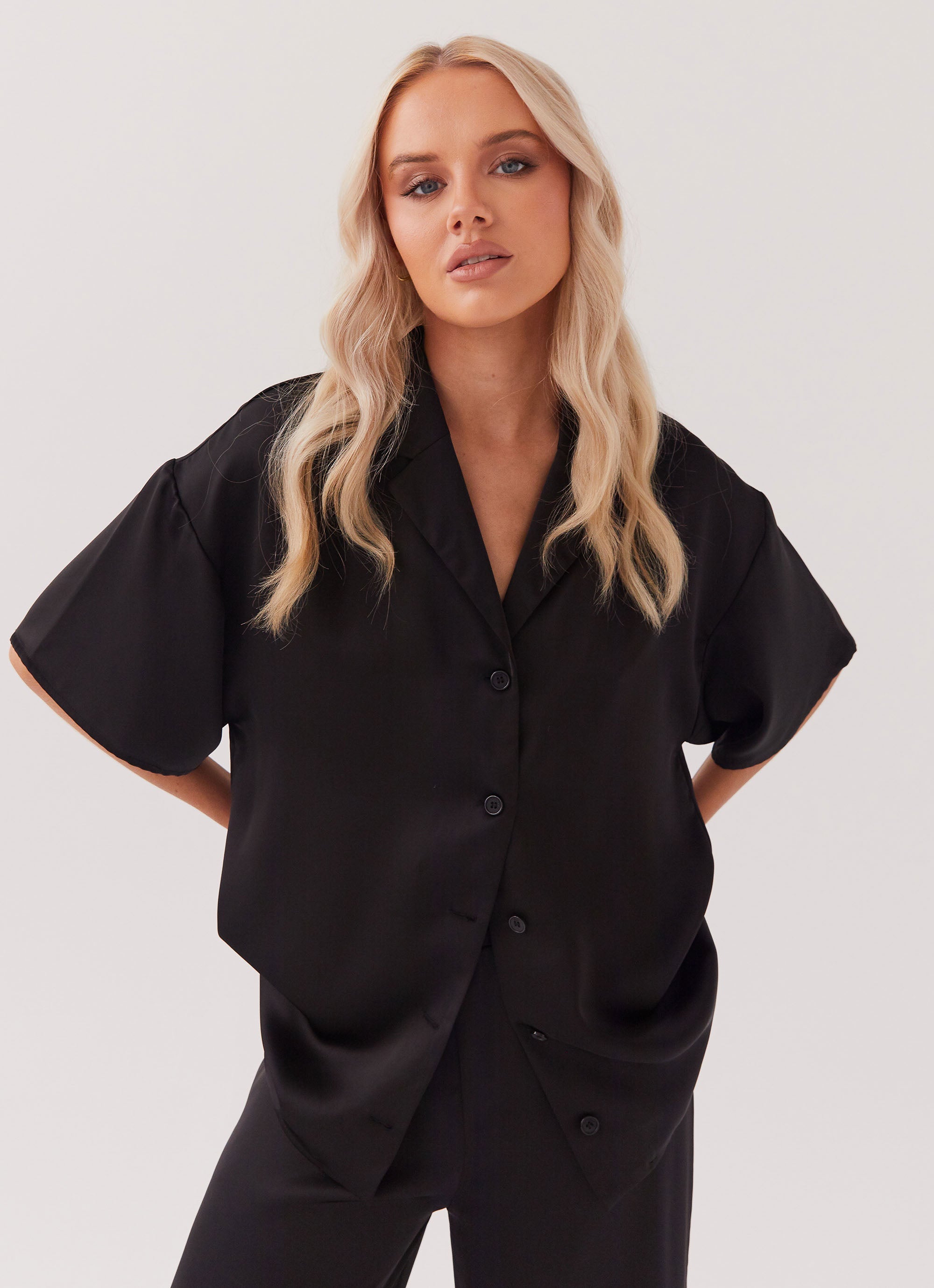 Womens Palm Cove Satin Shirt in the colour Black in front of a light grey background