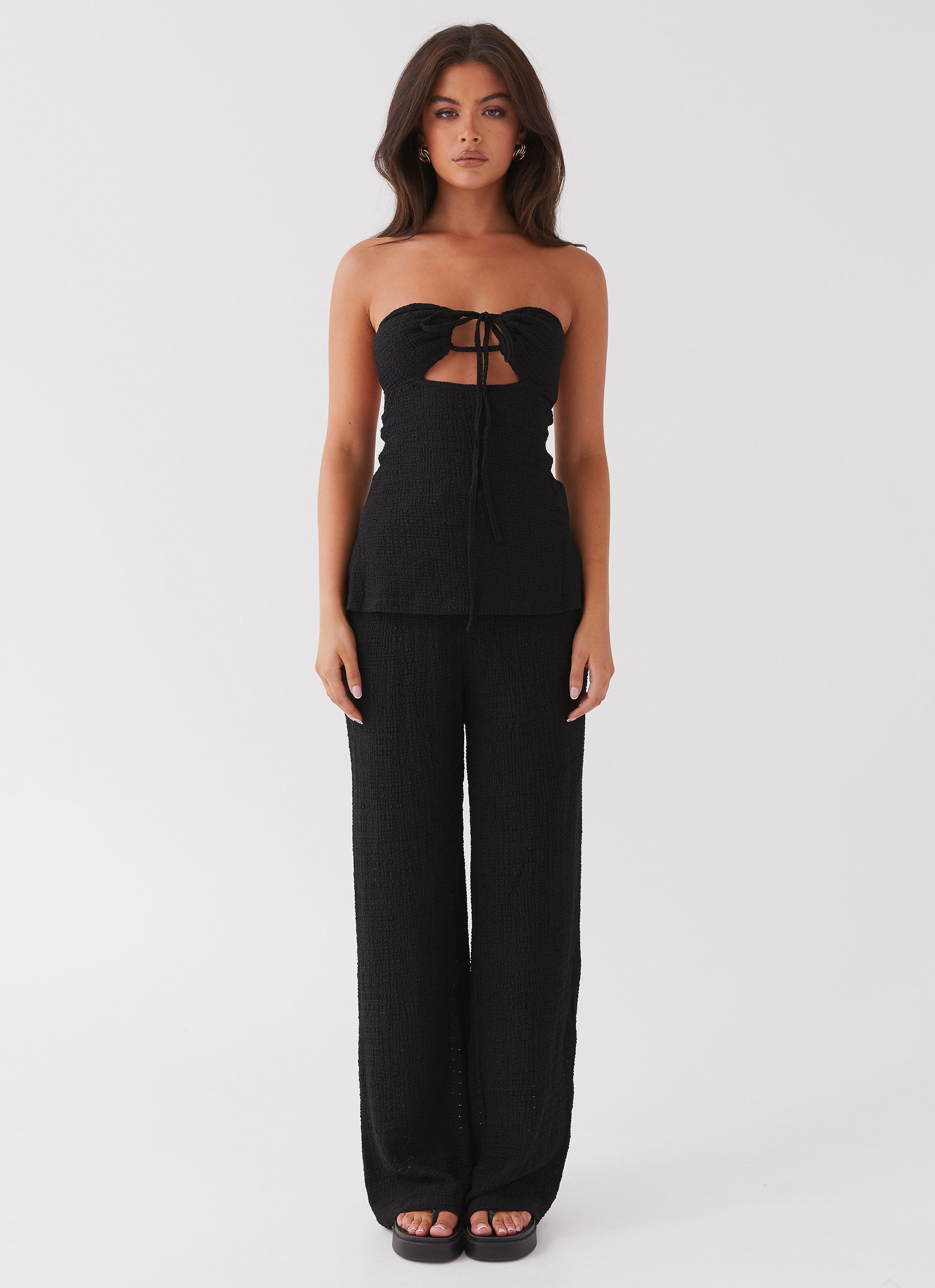 Womens Jadey Strapless Waffle Top in the colour Black in front of a light grey background