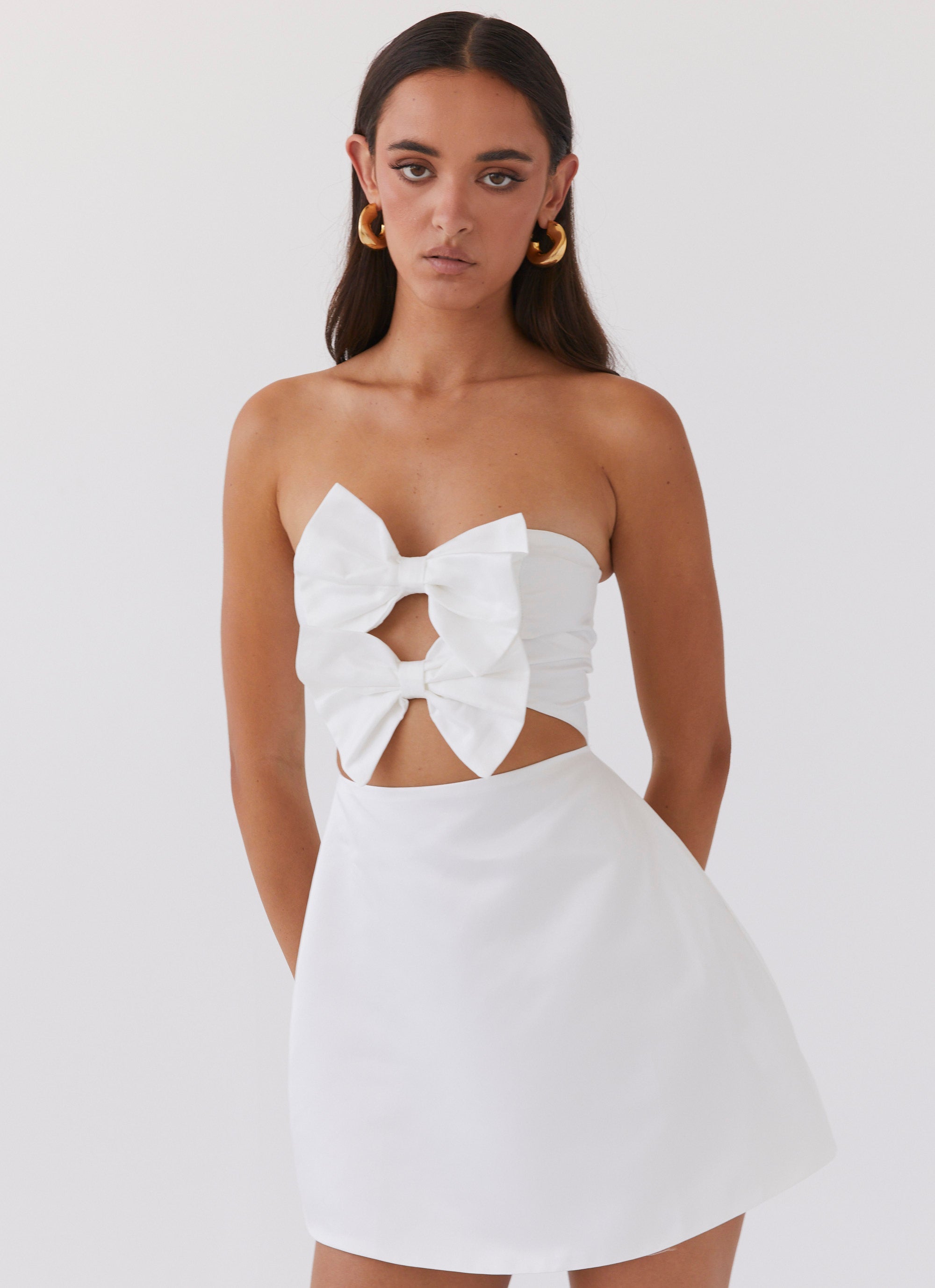 Womens Girl Crush Bow Mini Dress in the colour White in front of a light grey background