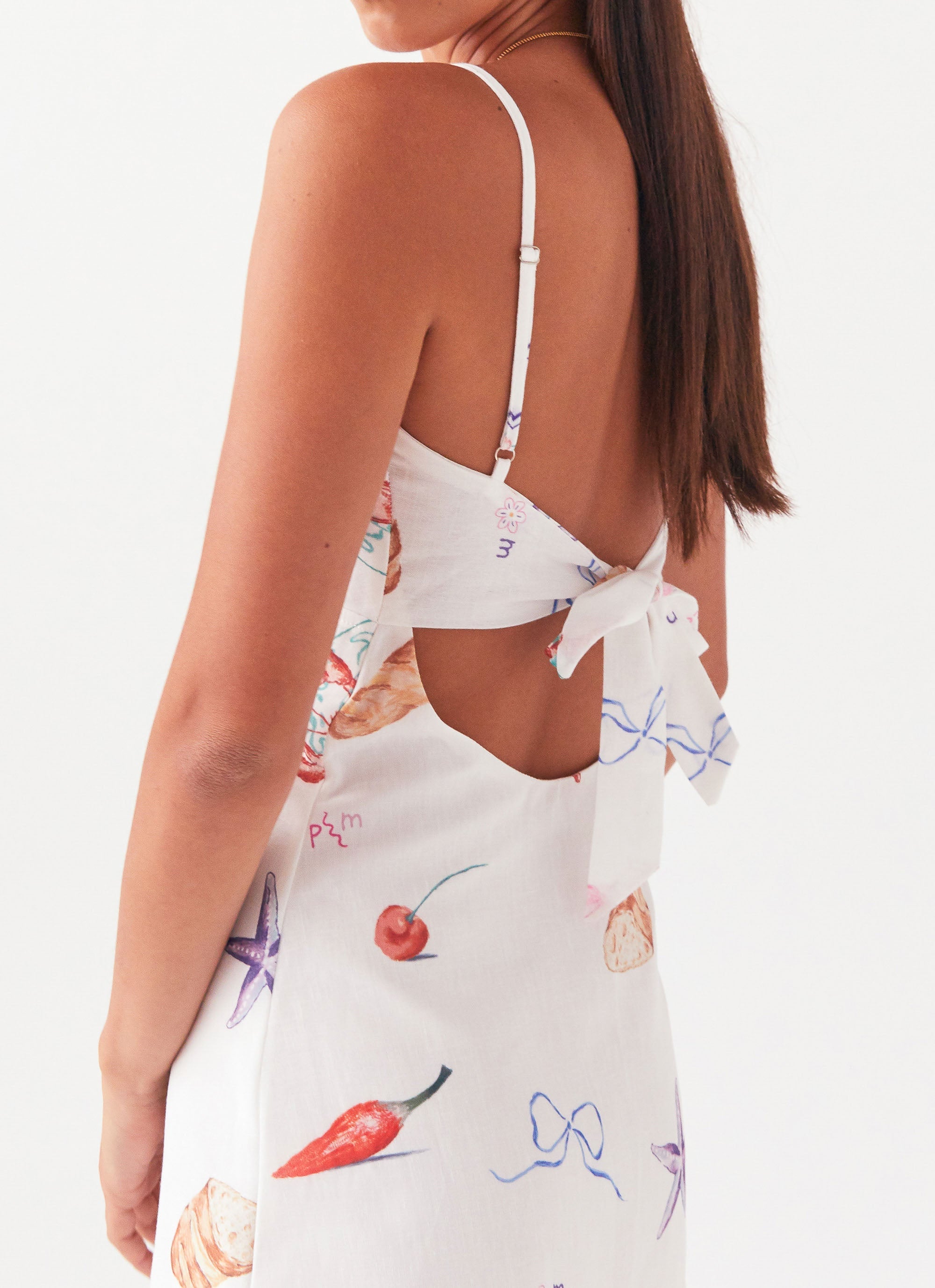 Womens Flora Linen Mini Dress in the colour Banchetto in front of a light grey background