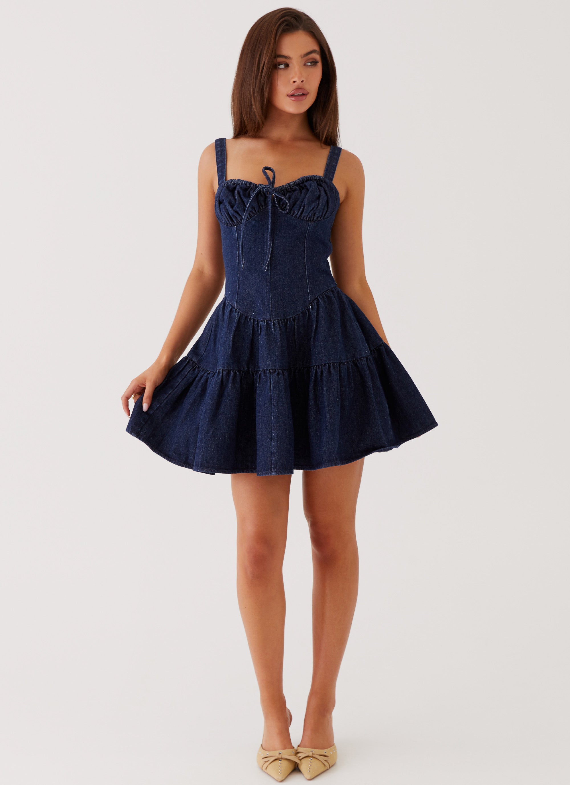 Womens Lucie Denim Mini Dress in the colour Indigo in front of a light grey background