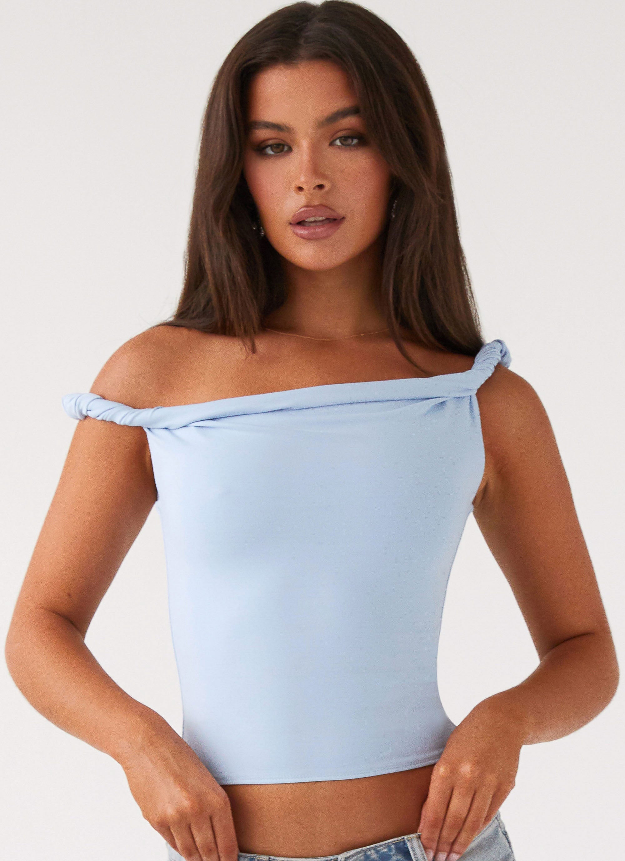 Womens Solace Soul Twist Shoulder Top in the colour Baby Blue in front of a light grey background
