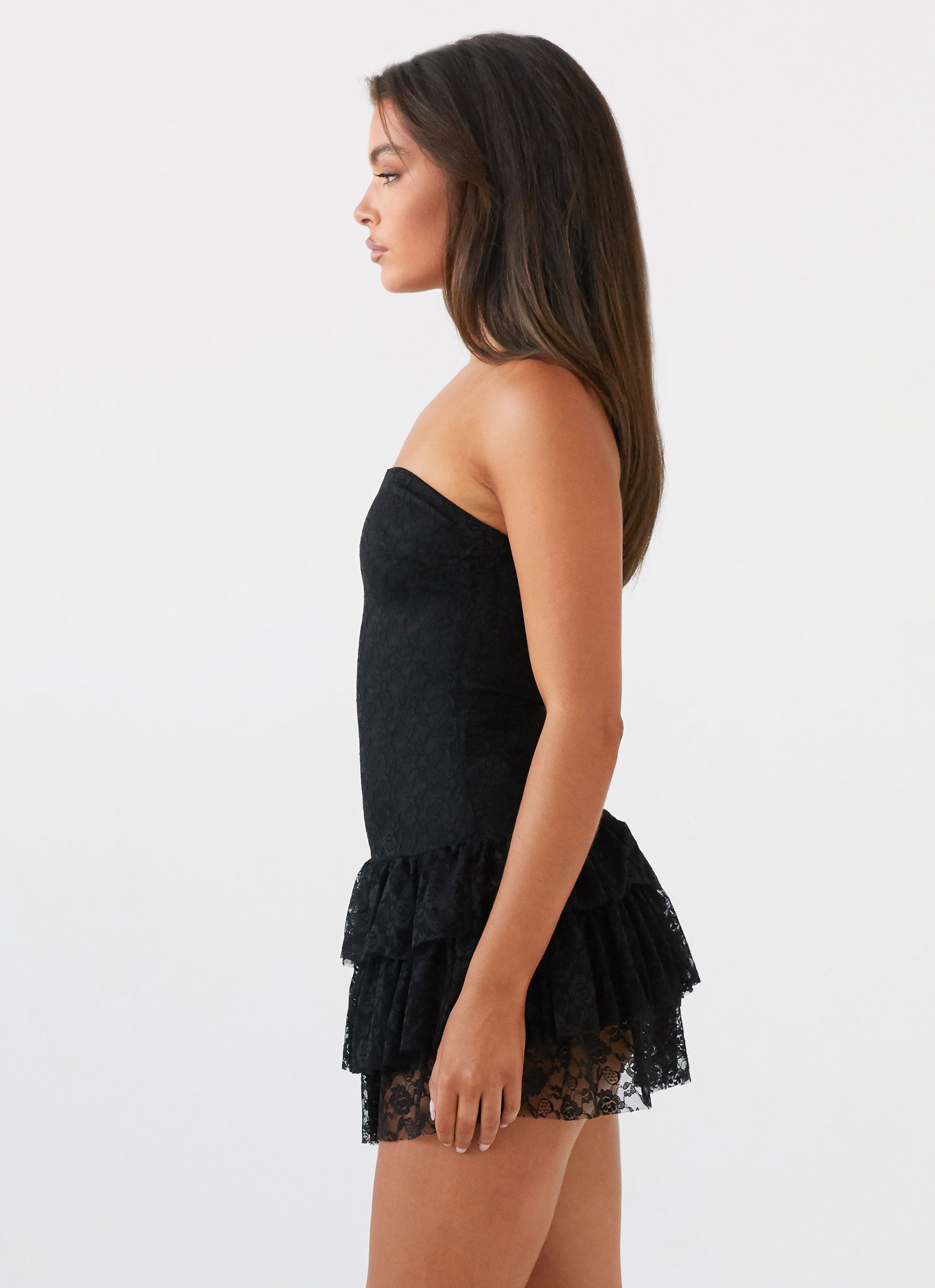 Womens Posie Lace Tube Mini Dress in the colour Black in front of a light grey background