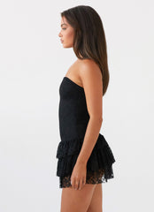 Womens Posie Lace Tube Mini Dress in the colour Black in front of a light grey background