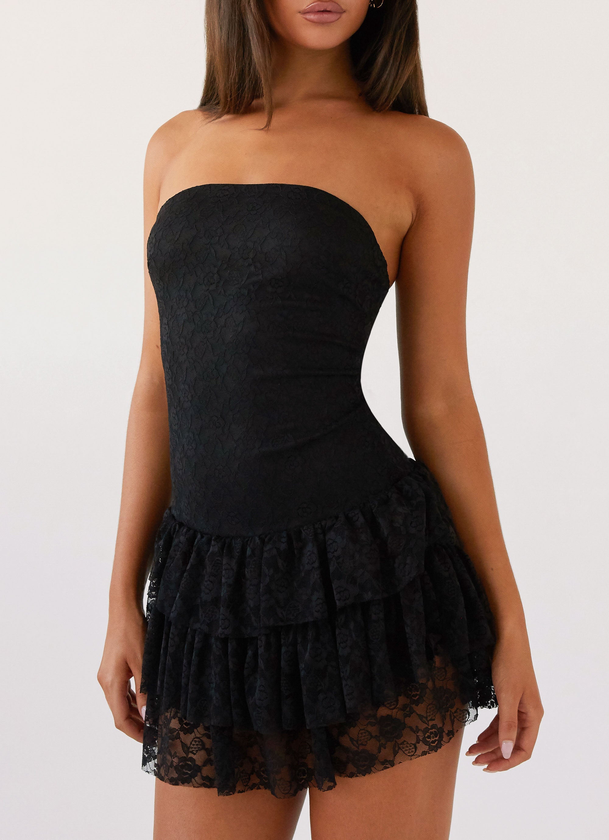 Womens Posie Lace Tube Mini Dress in the colour Black in front of a light grey background