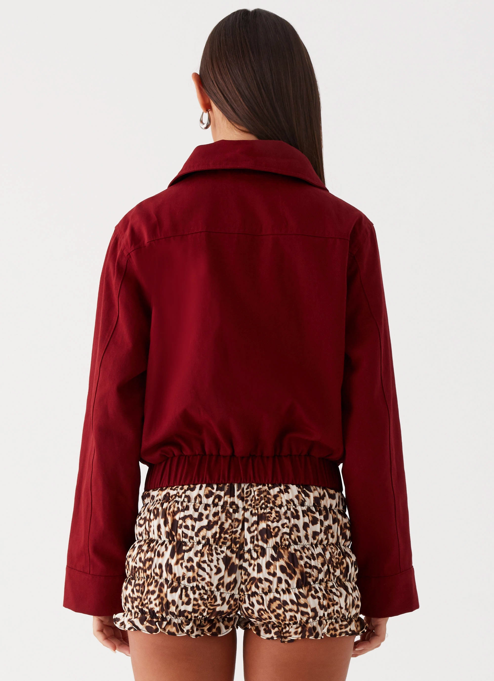 Womens Right Direction Oversized Bomber Jacket in the colour Deep Red in front of a light grey background
